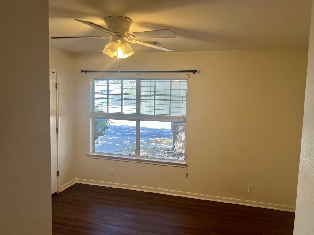 272 Tobin Drive Buda, TX 78610 - Photo 20 of 20 an empty room with wooden floor and windows