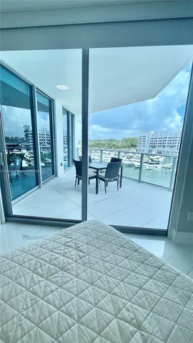 a view of a porch with a floor to ceiling window and a table