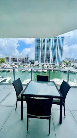 a view of a dining room with furniture and a floor to ceiling window