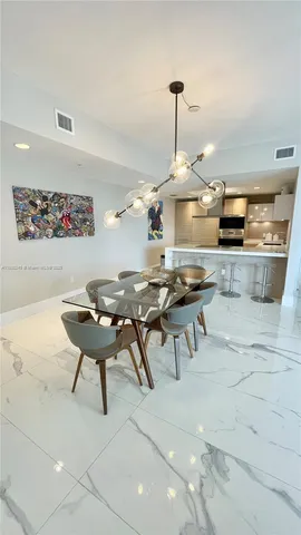 a living room with chairs and a table