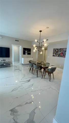 a view of a livingroom with furniture and a flat screen tv