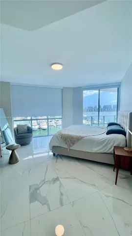 a bedroom with a bed and a couch