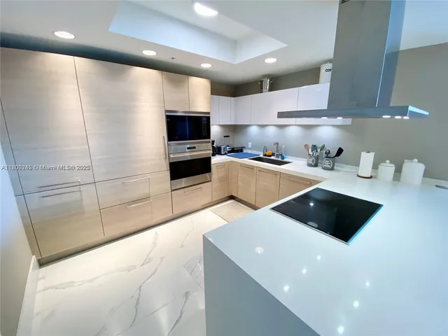 a kitchen with stainless steel appliances a stove a refrigerator and a sink