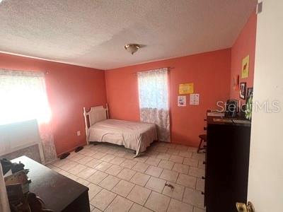 479 Water Road Ocala, FL 34472 - Photo 20 of 31 a bedroom with a bed and a lamp on dresser