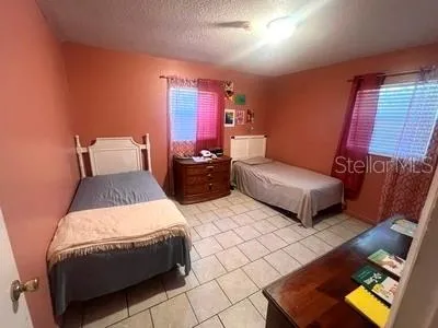 a bedroom with a bed and window