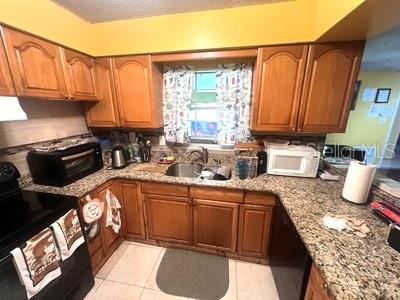 479 Water Road Ocala, FL 34472 - Photo 6 of 31 a kitchen with stainless steel appliances granite countertop a sink a stove and a microwave