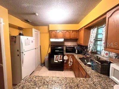 479 Water Road Ocala, FL 34472 - Photo 8 of 31 a kitchen with a refrigerator and a stove top oven