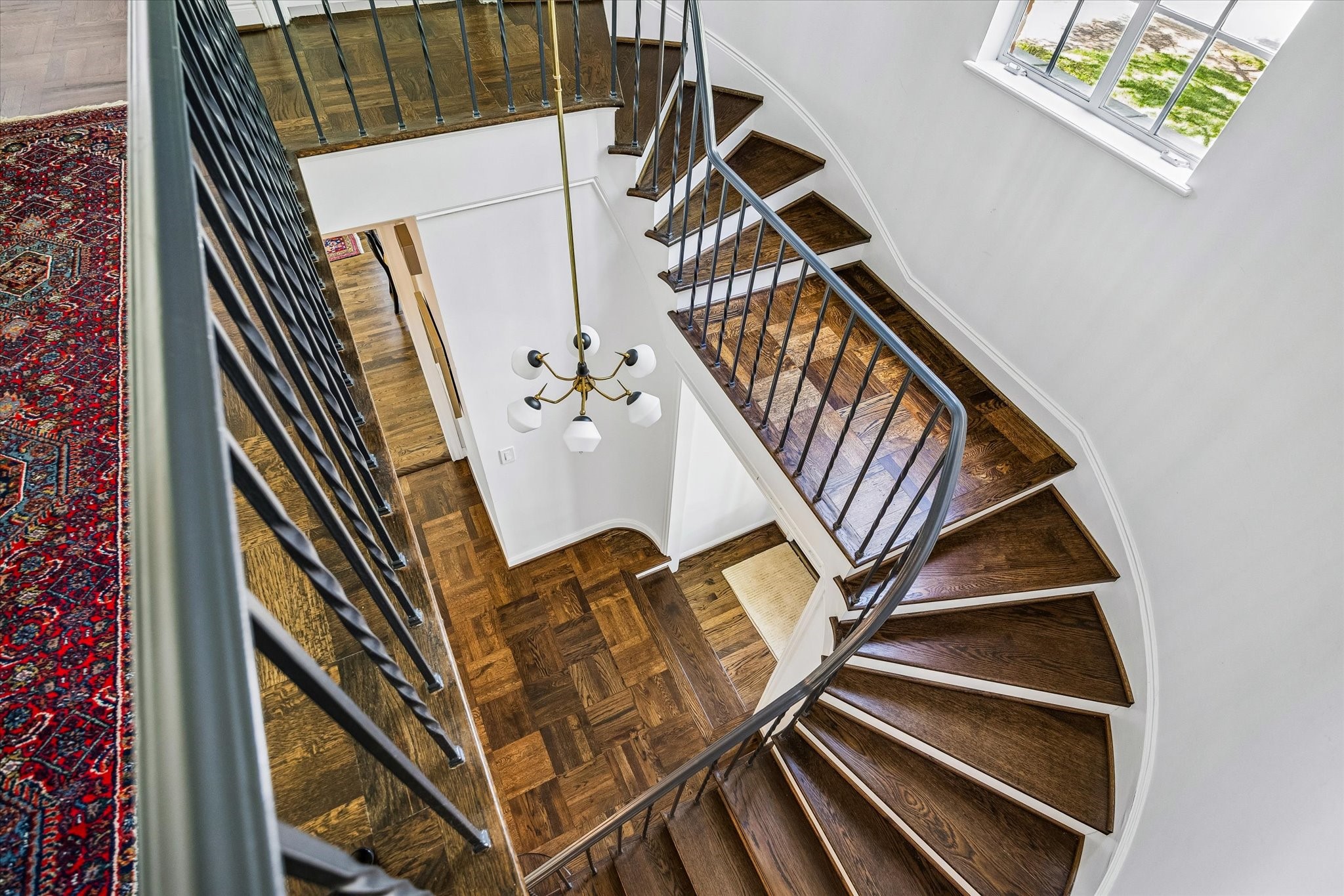 2133 Inwood Drive Houston, TX 77019 - Photo 14 of 22 From above, the sculptural staircase reveals its graceful form and layered textures.