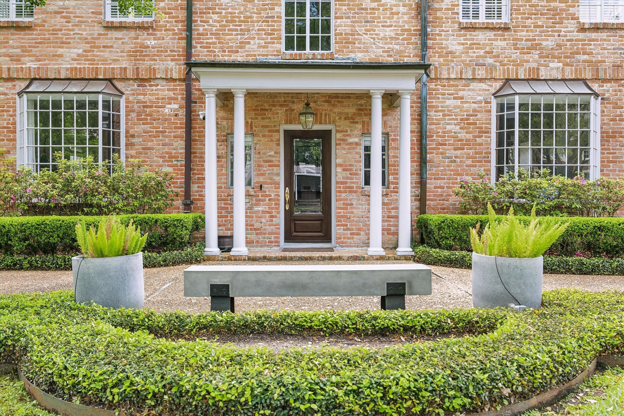 2133 Inwood Drive Houston, TX 77019 - Photo 2 of 22 A composed front vignette, where classic materials and structured landscaping create a polished first impression.