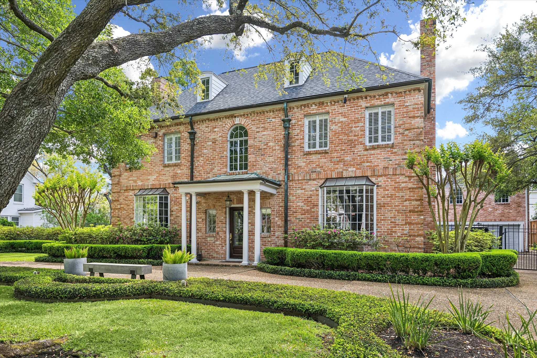 2133 Inwood Drive Houston, TX 77019 - Photo 21 of 22 A circular motor court introduces the home, where traditional architecture meets thoughtfully composed landscaping.