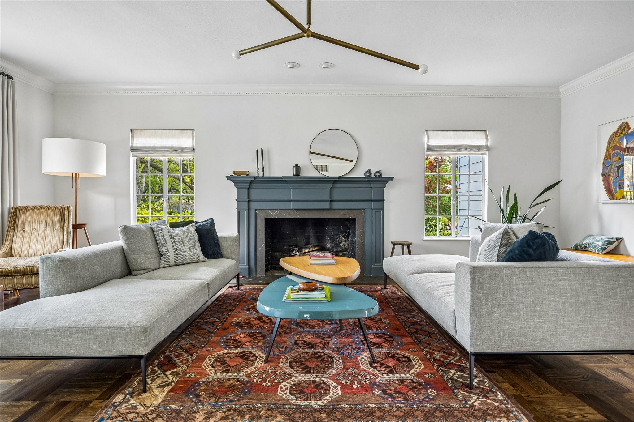 2133 Inwood Drive Houston, TX 77019 - Photo 6 of 22 From this angle in the living room, you capture its minimalist design, with a stylish fireplace, large windows to provide ample natural light, and a chic light fixture that adds a contemporary touch.