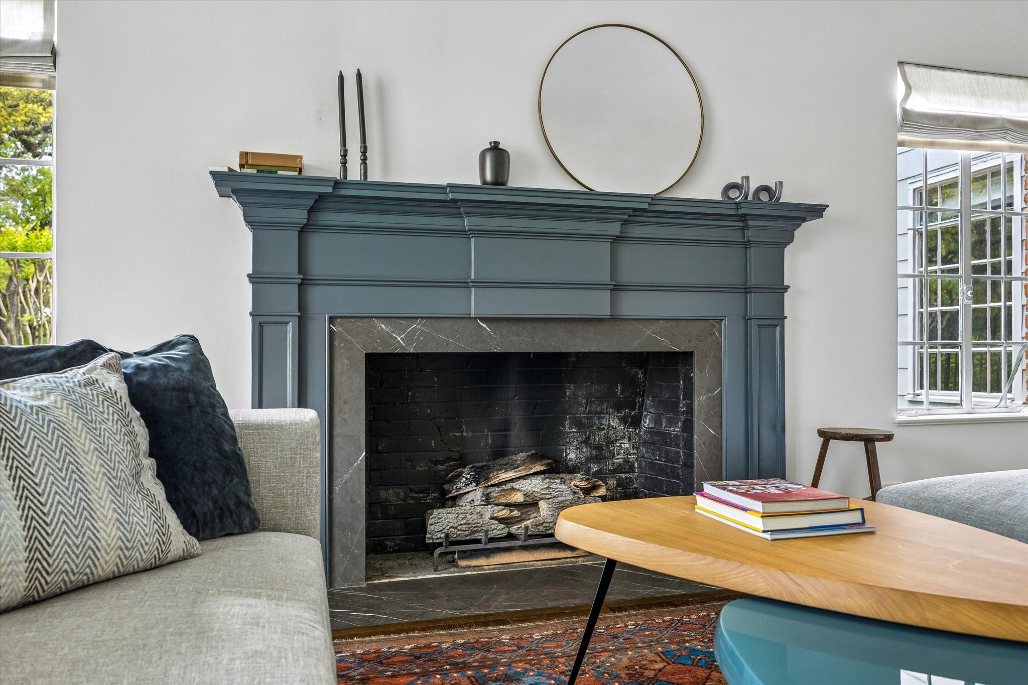 2133 Inwood Drive Houston, TX 77019 - Photo 7 of 22 A striking painted fireplace mantel with a marble surround anchors the living room, introducing subtle color and contrast to the home’s timeless design