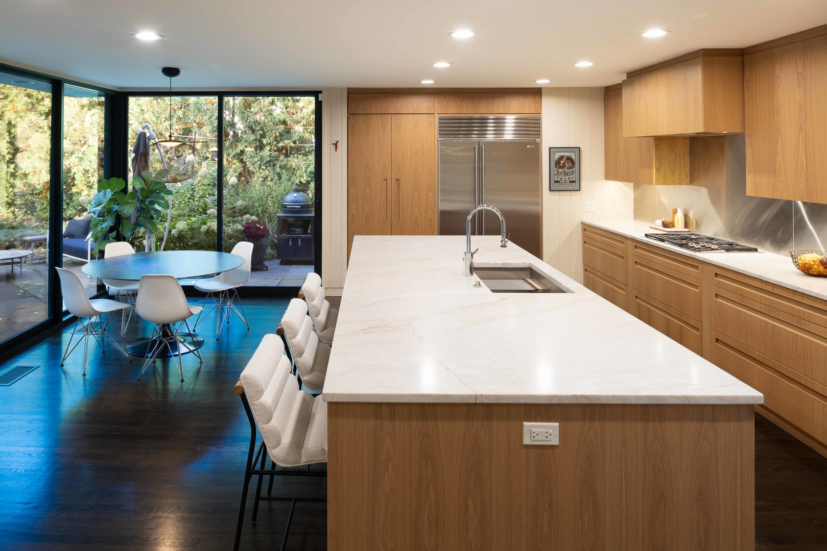 296 White Oak Lane Winnetka, IL 60093 - Photo 14 of 42 a kitchen with stainless steel appliances sink microwave dining table and chairs