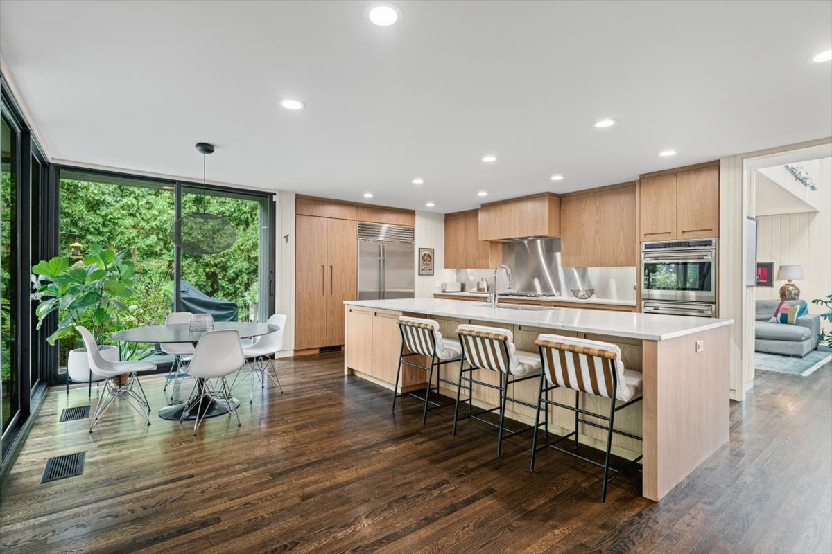 296 White Oak Lane Winnetka, IL 60093 - Photo 16 of 42 a kitchen with stainless steel appliances granite countertop a stove a sink a refrigerator with white cabinets and wooden floor