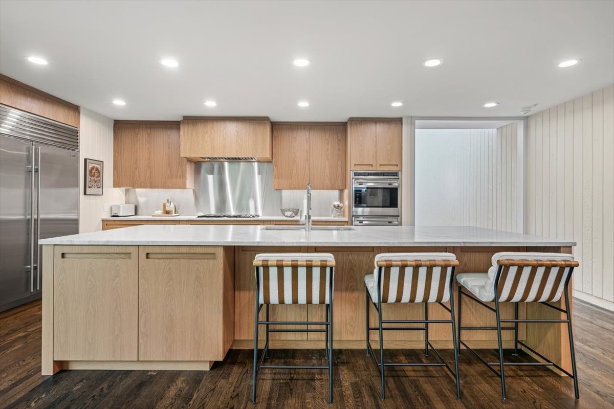 296 White Oak Lane Winnetka, IL 60093 - Photo 17 of 42 a kitchen with a table chairs microwave and cabinets
