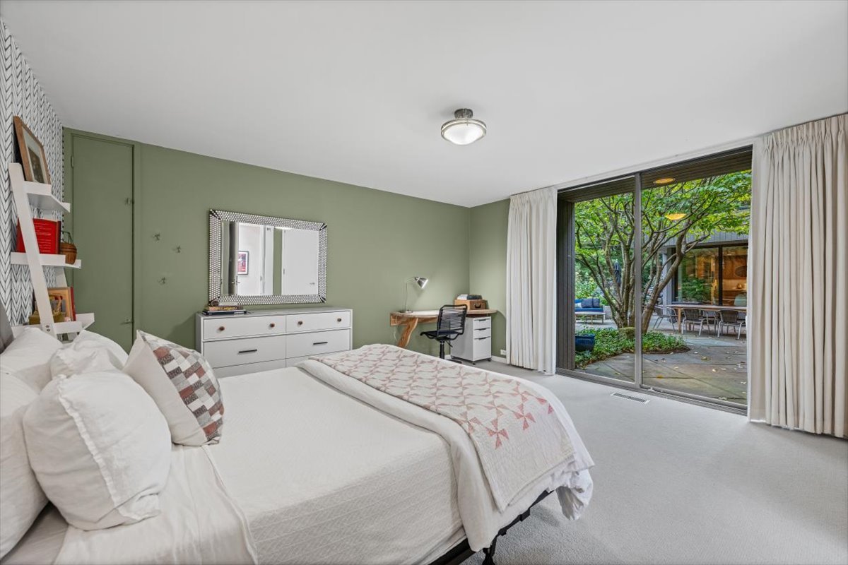 296 White Oak Lane Winnetka, IL 60093 - Photo 28 of 42 a bedroom with a balcony a bed and a couch