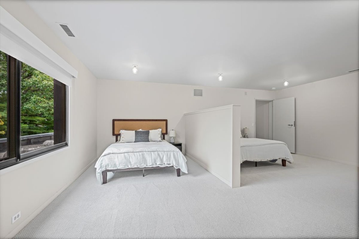 296 White Oak Lane Winnetka, IL 60093 - Photo 35 of 42 a spacious bedroom with a bed and large window