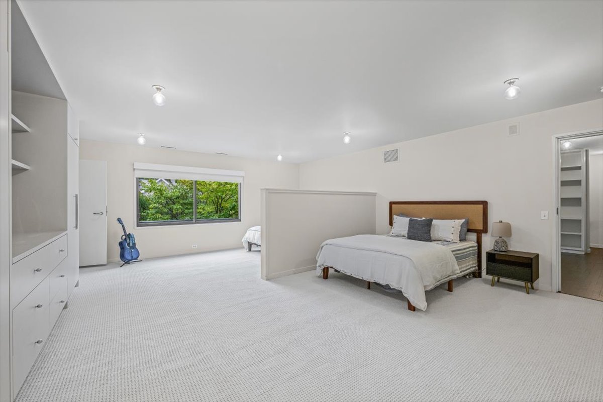 296 White Oak Lane Winnetka, IL 60093 - Photo 37 of 42 a spacious bedroom with a bed and a large window