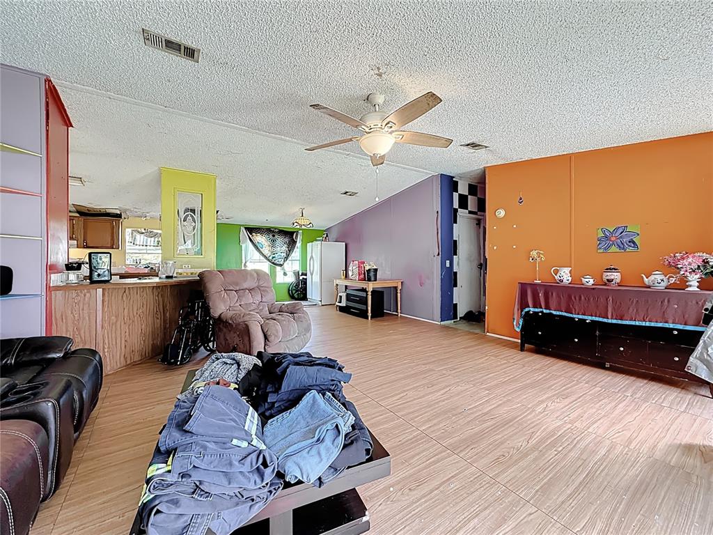 2414 Brock Road Plant City, FL 33565 - Photo 15 of 63 a bed room with a bed window and a chandelier