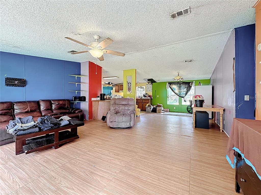 2414 Brock Road Plant City, FL 33565 - Photo 18 of 63 a living room with furniture and a chandelier