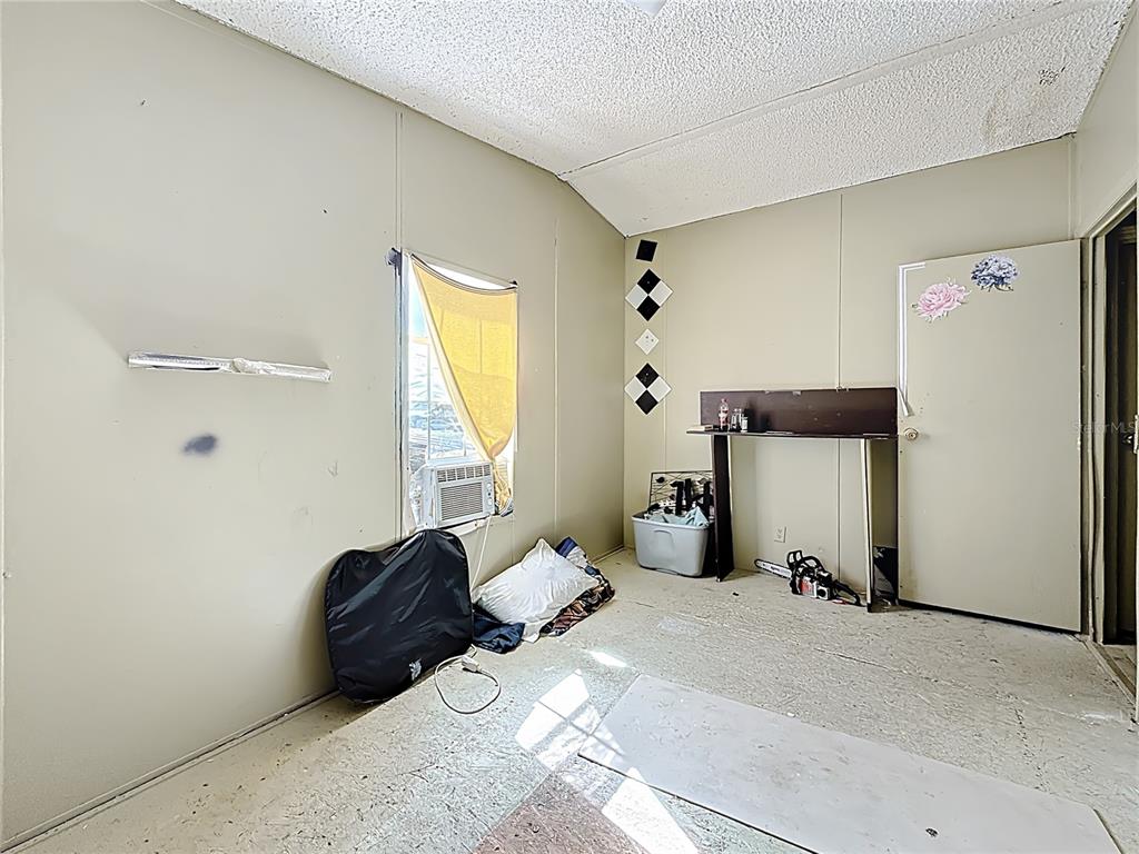 2414 Brock Road Plant City, FL 33565 - Photo 26 of 63 a bedroom with a bed and a window