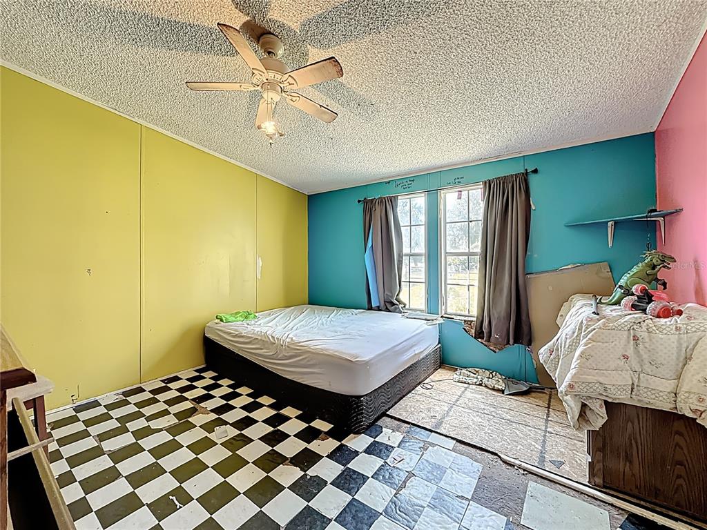 2414 Brock Road Plant City, FL 33565 - Photo 42 of 63 a bedroom with a bed and window
