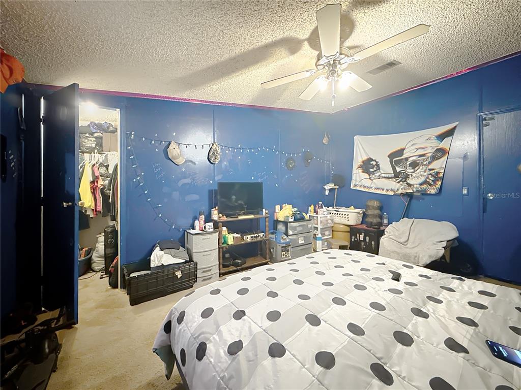 2414 Brock Road Plant City, FL 33565 - Photo 45 of 63 a bedroom with bed and a chandelier