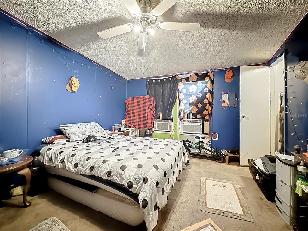 2414 Brock Road Plant City, FL 33565 - Photo 46 of 63 a bedroom with a bed and a chandelier