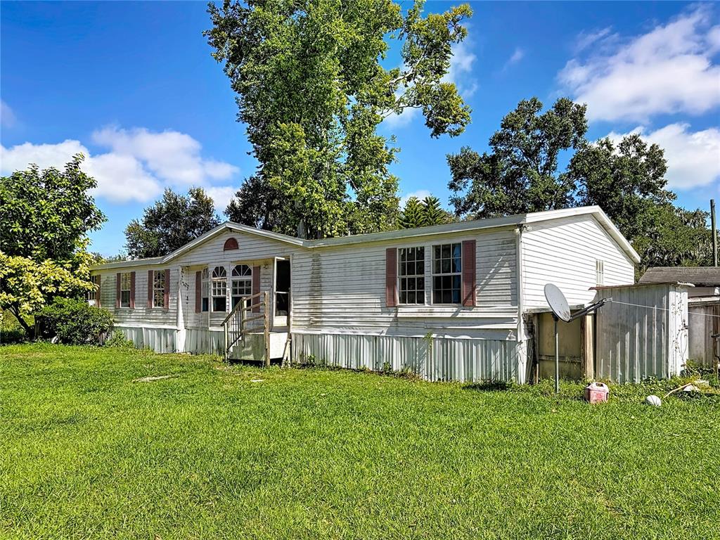 2414 Brock Road Plant City, FL 33565 - Photo 48 of 63 a front view of a house with a yard