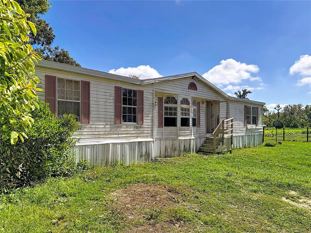 2414 Brock Road Plant City, FL 33565 - Photo 49 of 63 a front view of a house with yard and glass windows