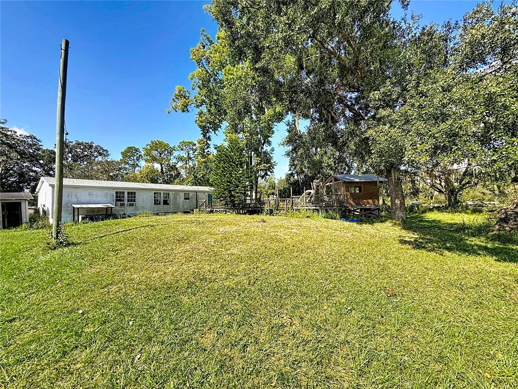 2414 Brock Road Plant City, FL 33565 - Photo 57 of 63 a view of a house with a yard