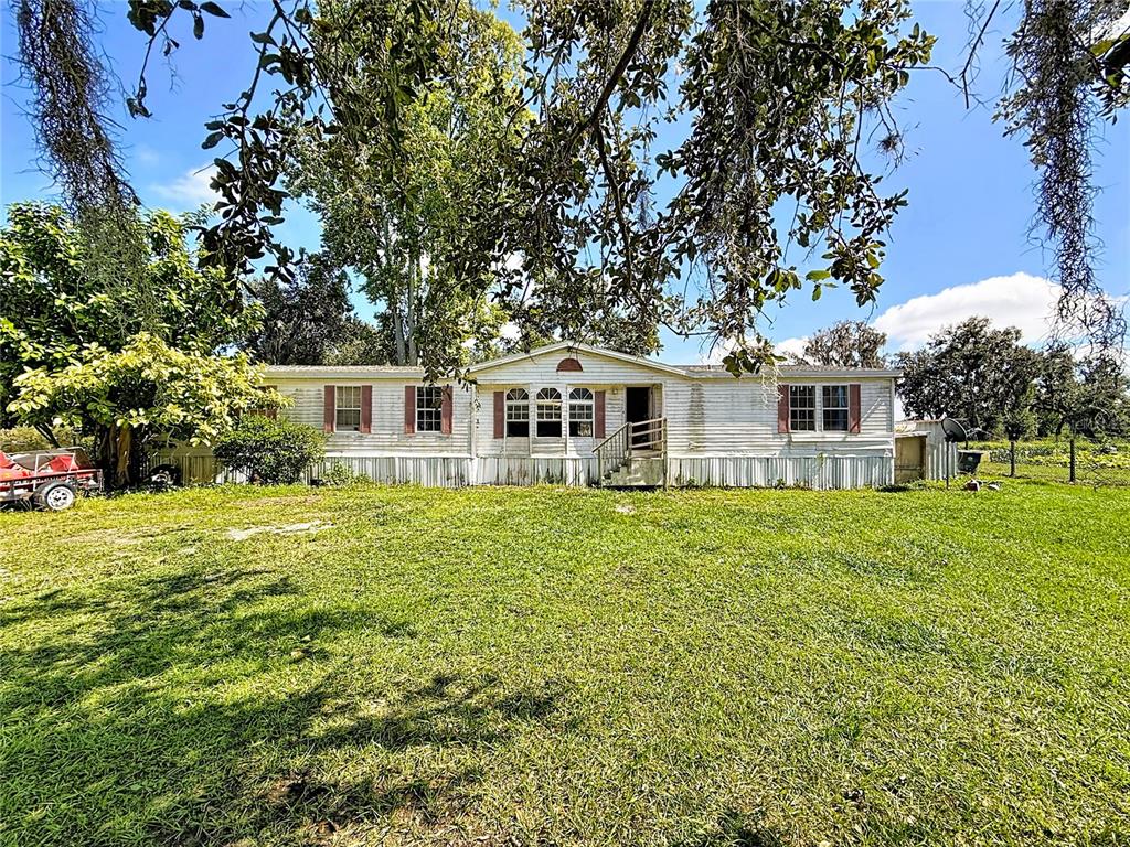 2414 Brock Road Plant City, FL 33565 - Photo 8 of 63 a front view of a house with a garden