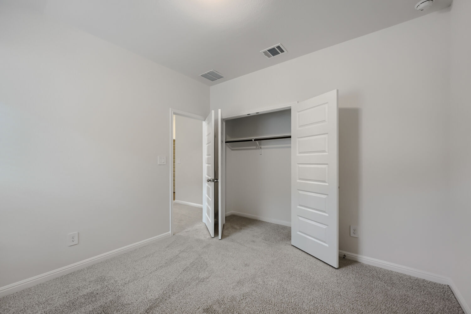 146 Diablo Rim Terrace Dripping Springs, TX 78620 - Photo 22 of 32 Step into this pristine bedroom featuring soft carpeting and a spacious, organized closet.