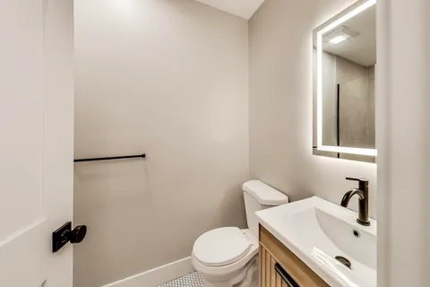 a bathroom with a sink toilet and vanity