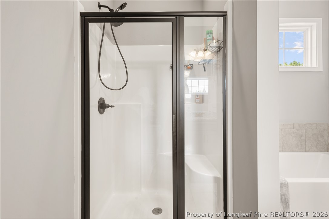 137 Minter School Road Sanford, NC 27332 - Photo 21 of 50 a bathroom with a glass shower door