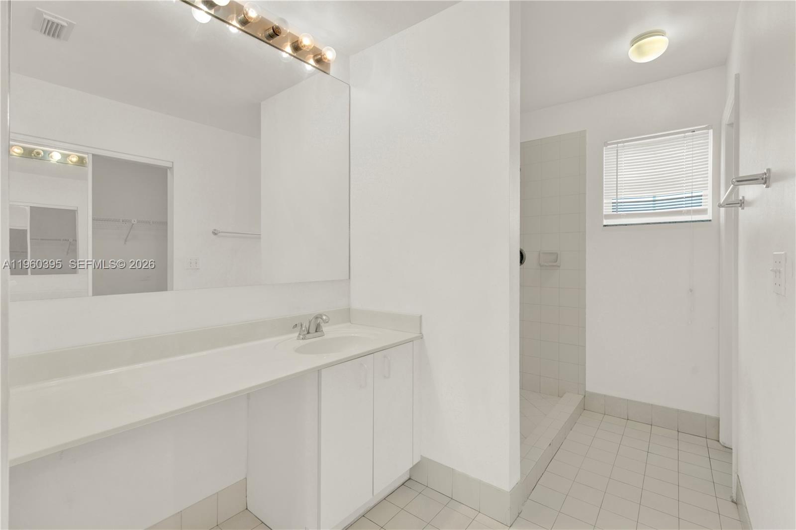 11321 Southwest 62nd Lane Miami, FL 33173 - Photo 18 of 43 a bathroom with a sink and a mirror