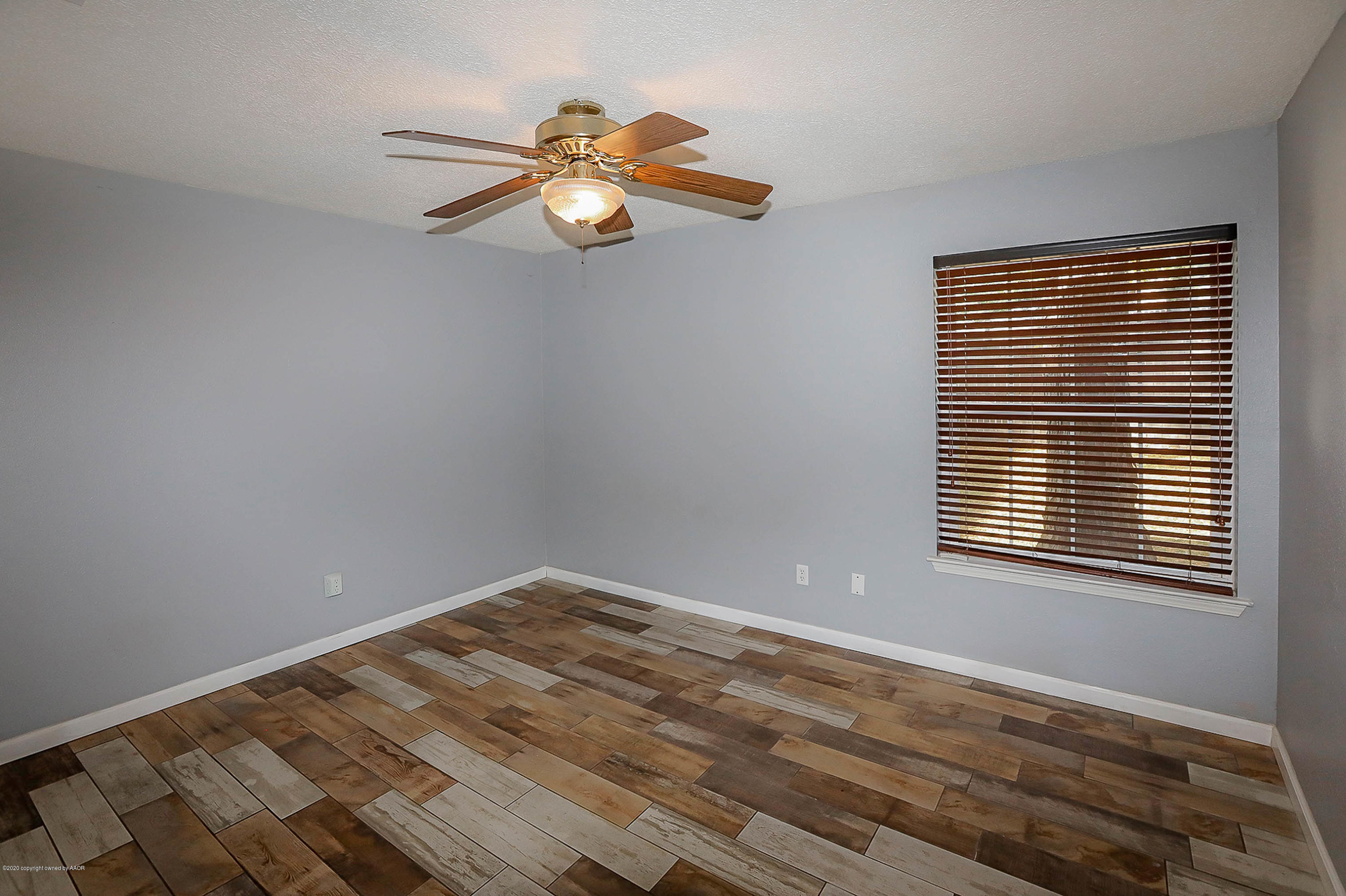 2802 Shield Court Amarillo, TX 79110 - Photo 14 of 32 a view of a room with wooden floor and a window