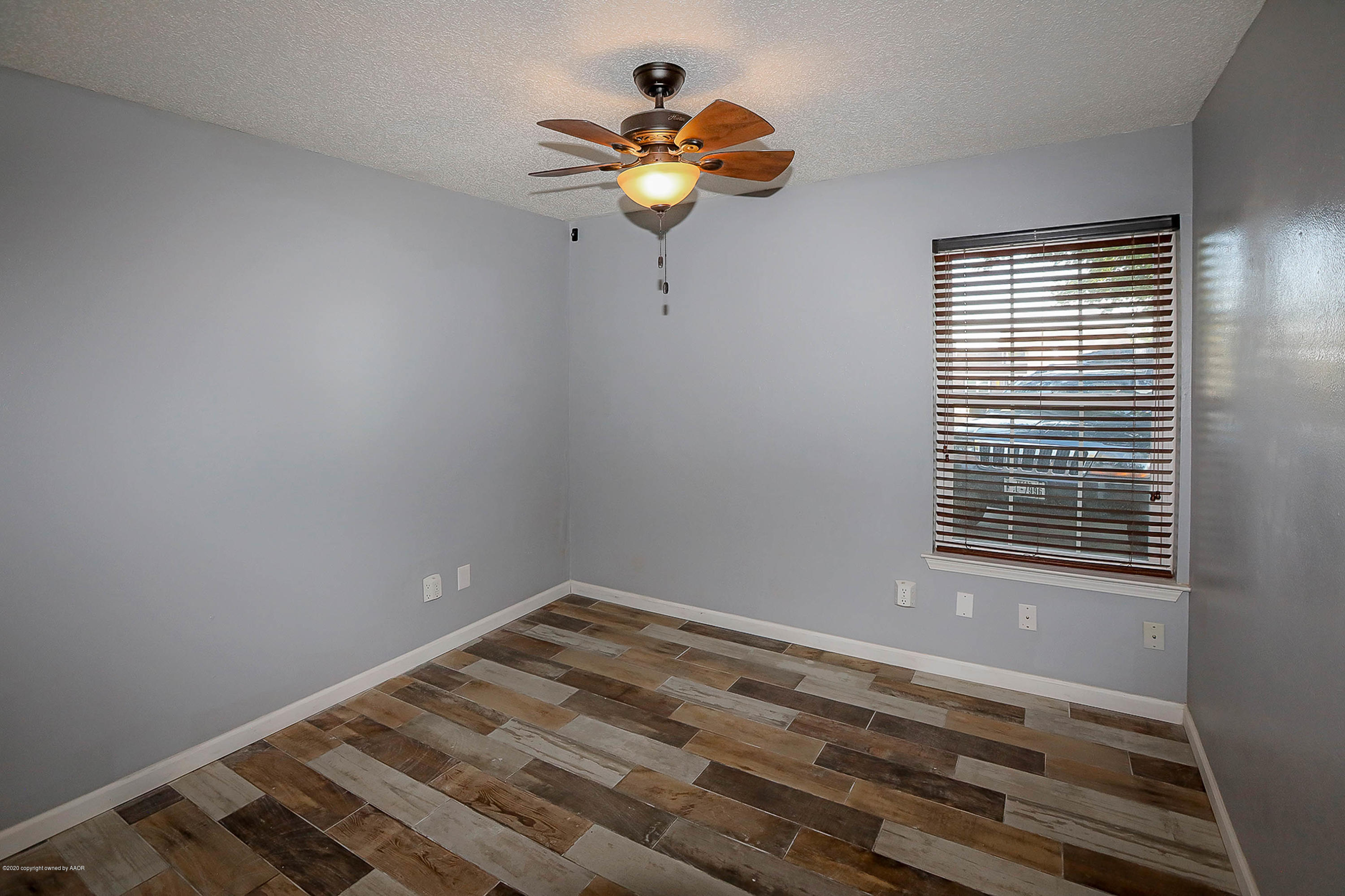 2802 Shield Court Amarillo, TX 79110 - Photo 20 of 32 a view of wooden floor and a chandelier fan in a room