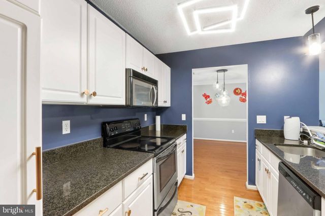 a view of a room with wooden floor and window