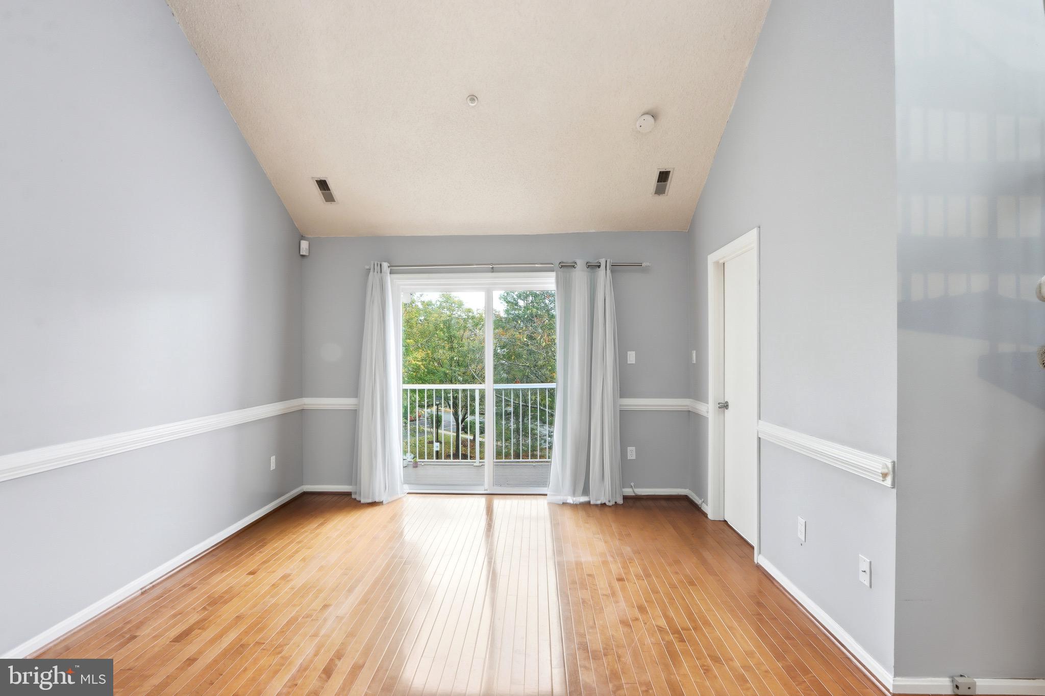 12909 Churchill Ridge Circle, Unit 12 Germantown, MD 20874 - Photo 16 of 44 a view of a room with wooden floor and window