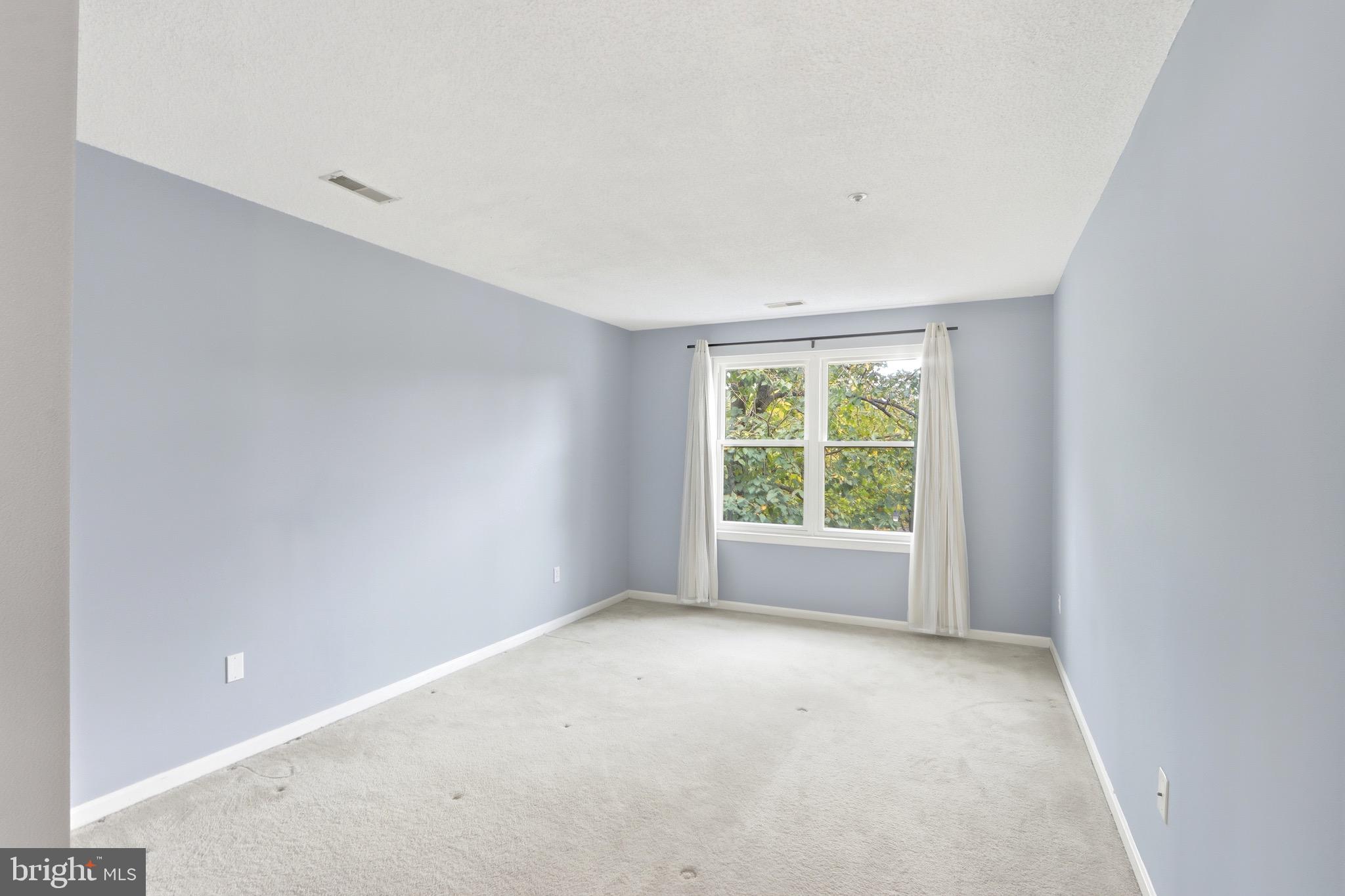 12909 Churchill Ridge Circle, Unit 12 Germantown, MD 20874 - Photo 19 of 44 a view of an empty room with a window