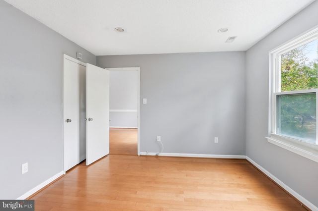 a view of a livingroom with wooden floor and cabinet
