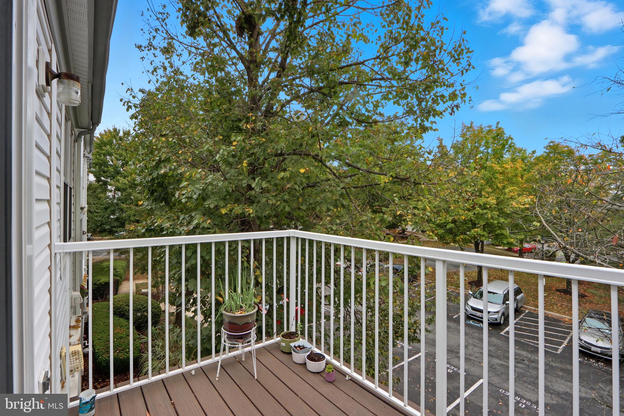 12909 Churchill Ridge Circle, Unit 12 Germantown, MD 20874 - Photo 32 of 44 a view of balcony with wooden floor and fence