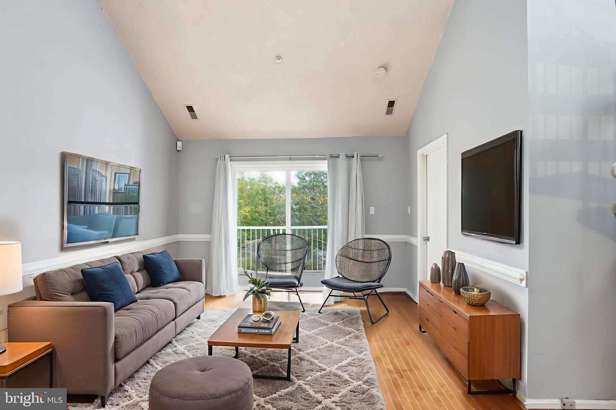 12909 Churchill Ridge Circle, Unit 12 Germantown, MD 20874 - Photo 36 of 44 a living room with furniture a flat screen tv and a large window