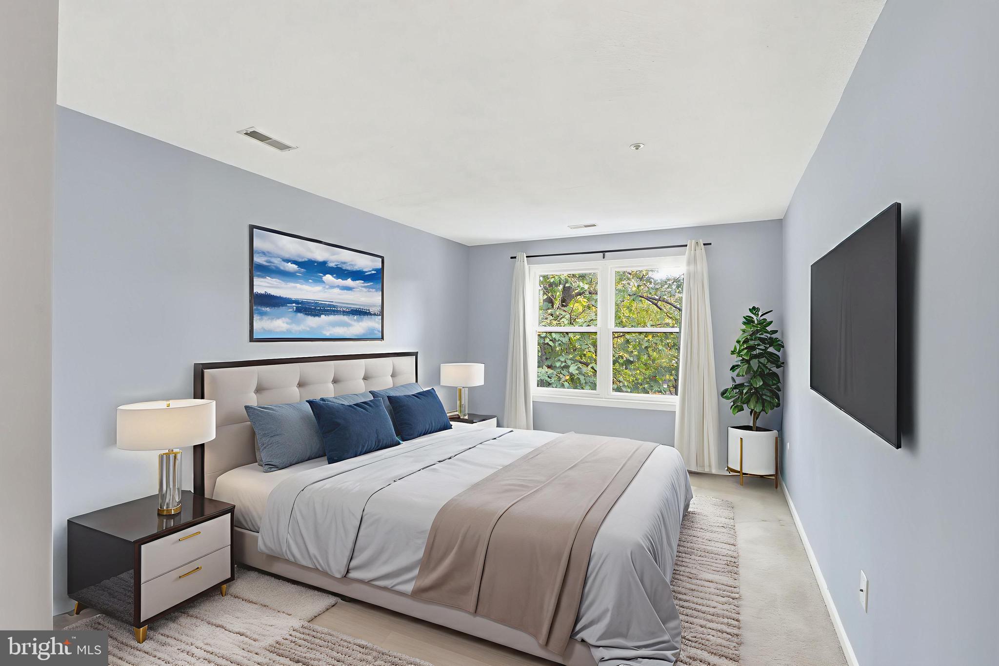 12909 Churchill Ridge Circle, Unit 12 Germantown, MD 20874 - Photo 41 of 44 a bedroom with a bed and a flat screen tv