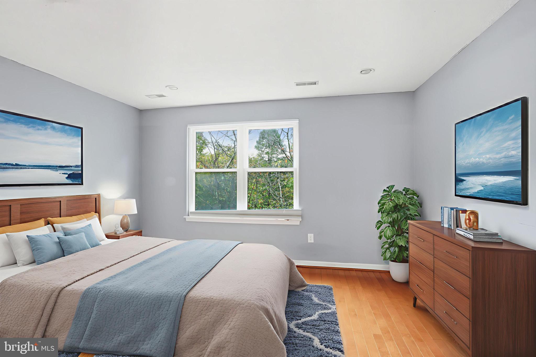 12909 Churchill Ridge Circle, Unit 12 Germantown, MD 20874 - Photo 43 of 44 a bedroom with a bed and a flat screen tv