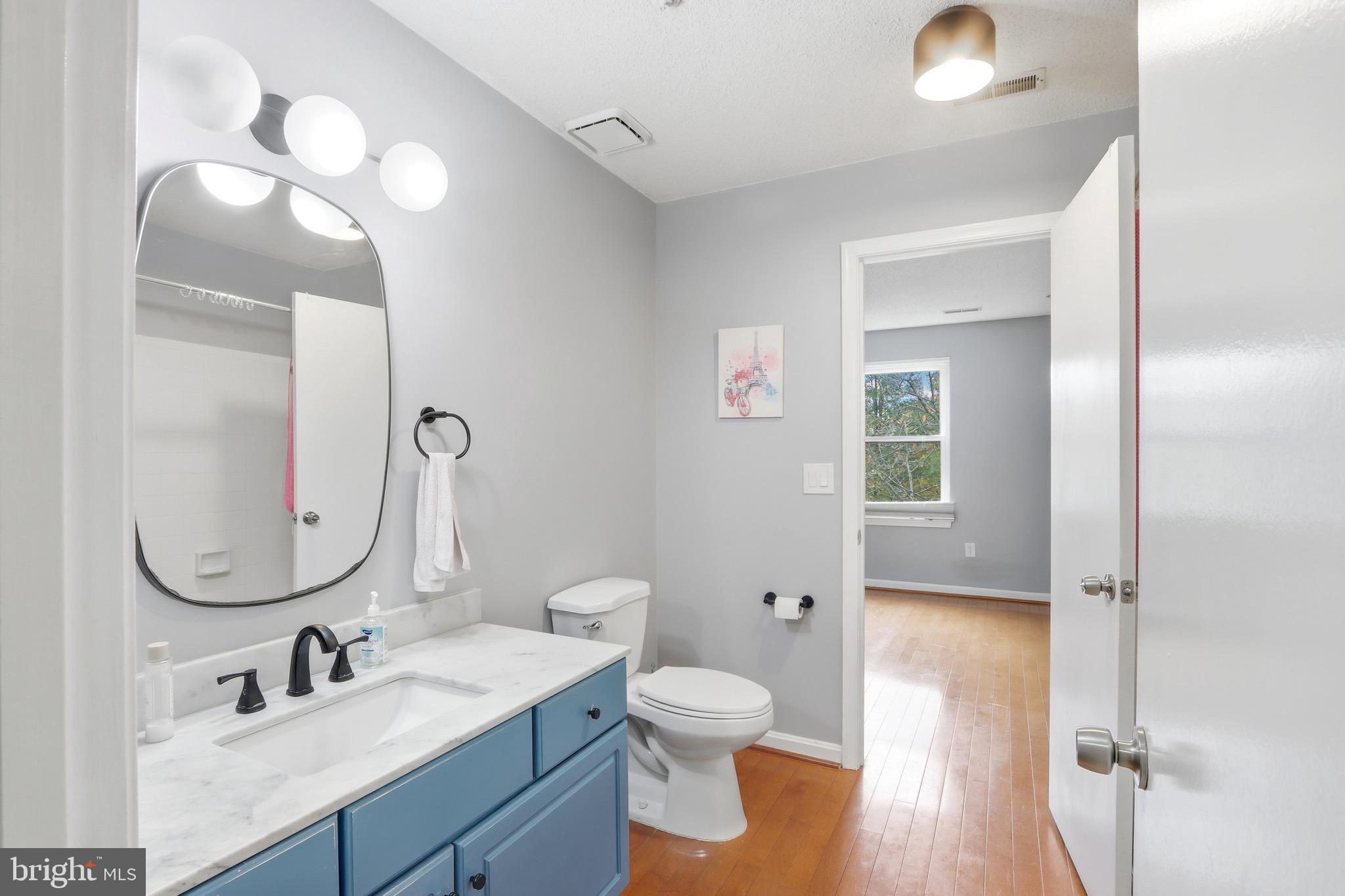 12909 Churchill Ridge Circle, Unit 12 Germantown, MD 20874 - Photo 9 of 44 a bathroom with a toilet sink and mirror