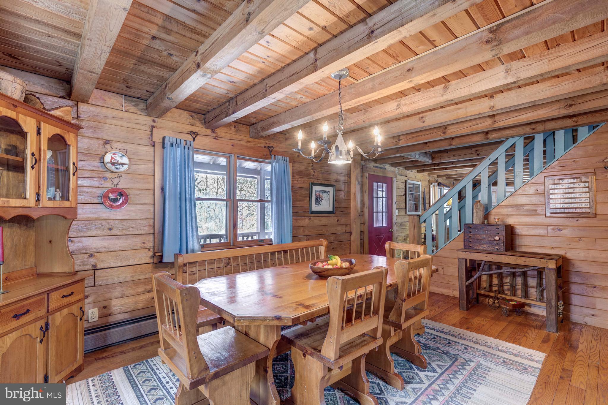 385 Silver Run Valley Road Westminster, MD 21158 - Photo 27 of 59 a dining room with furniture a rug and a chandelier