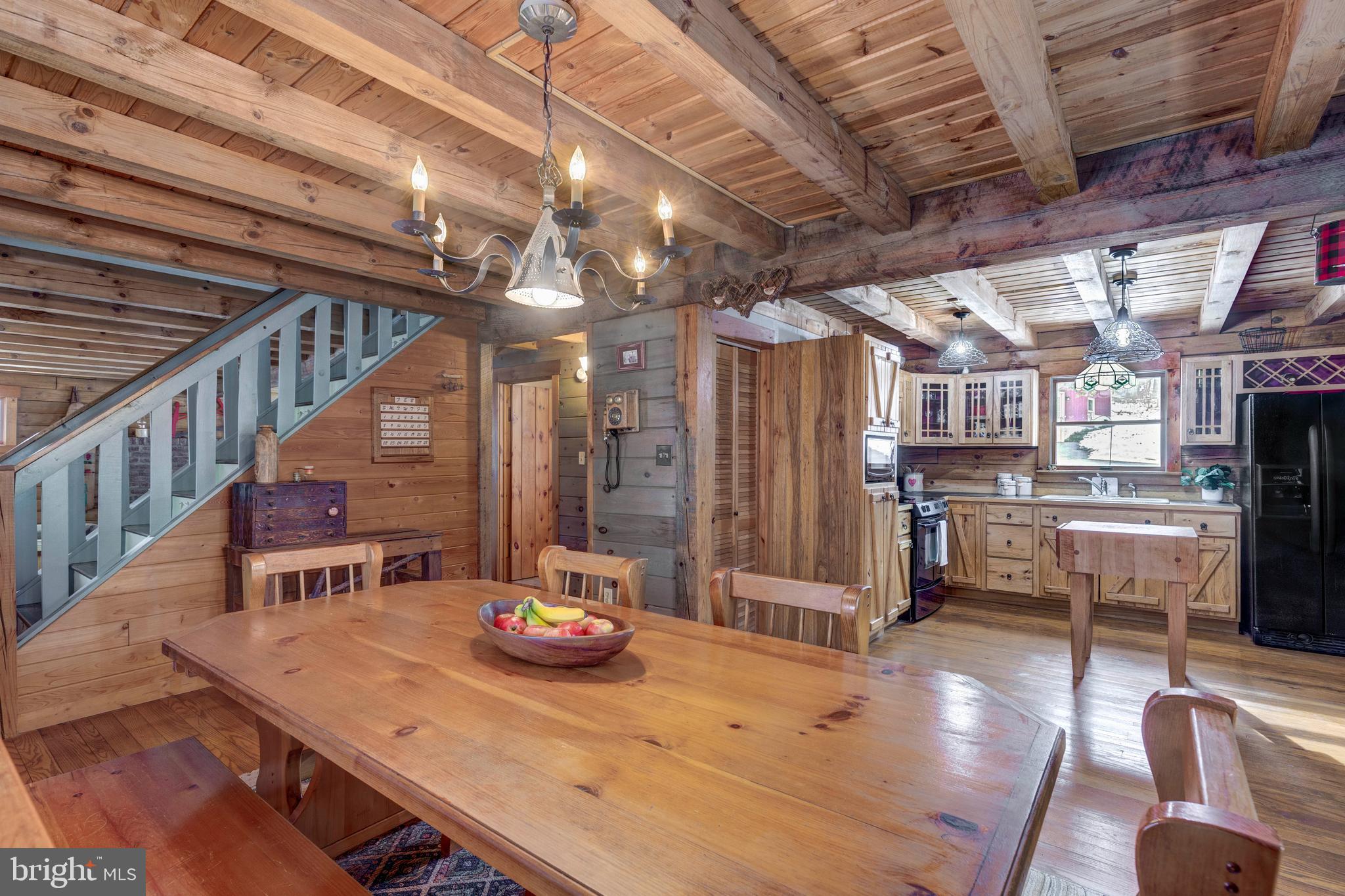 385 Silver Run Valley Road Westminster, MD 21158 - Photo 28 of 59 a view of a dining room with furniture a chandelier and wooden floor