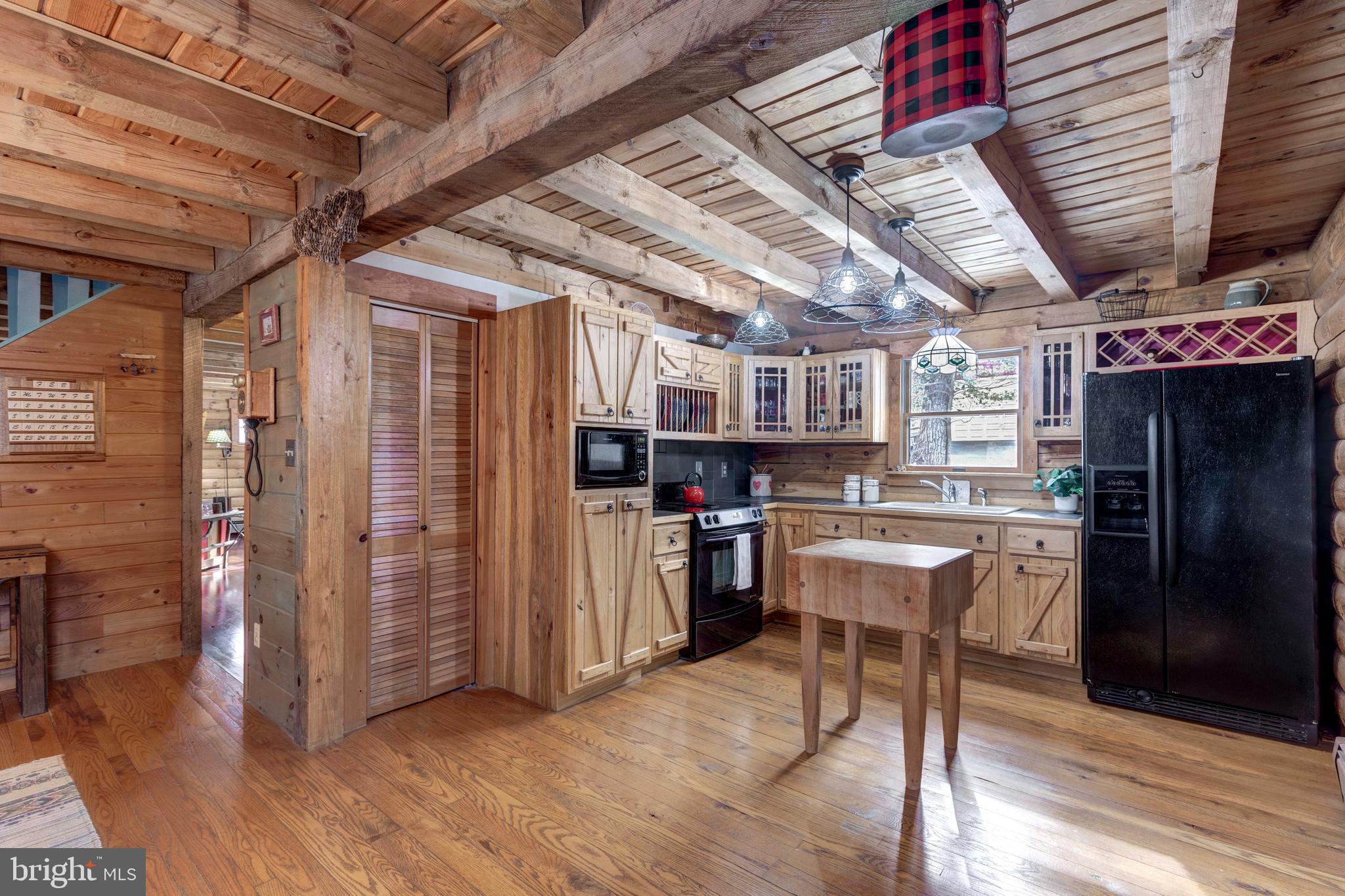 385 Silver Run Valley Road Westminster, MD 21158 - Photo 29 of 59 a open kitchen with stainless steel appliances granite countertop a table chairs and wooden floors